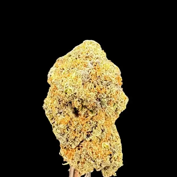 Close-up of a cannabis bud with dense frosty trichomes on a black background.